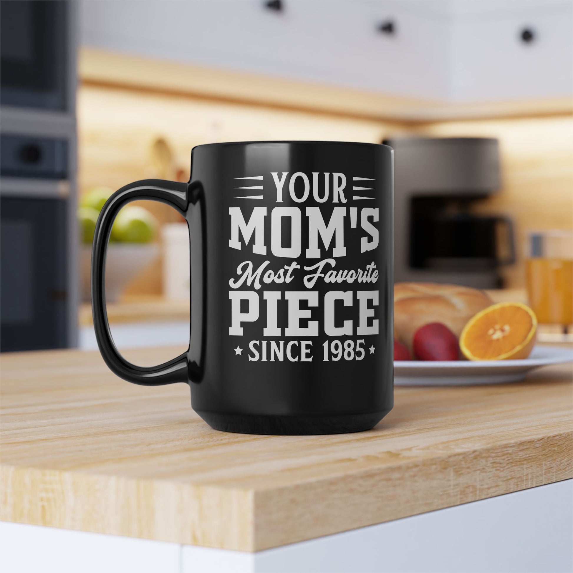 Black mug with white text on a kitchen counter
