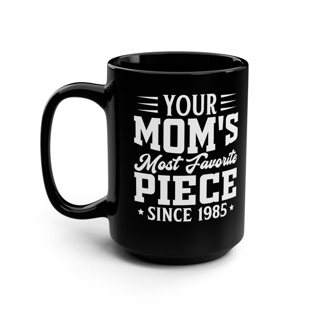 Black mug with white text 'Your Mom's Most Favorite Piece Since 1985' on a white background